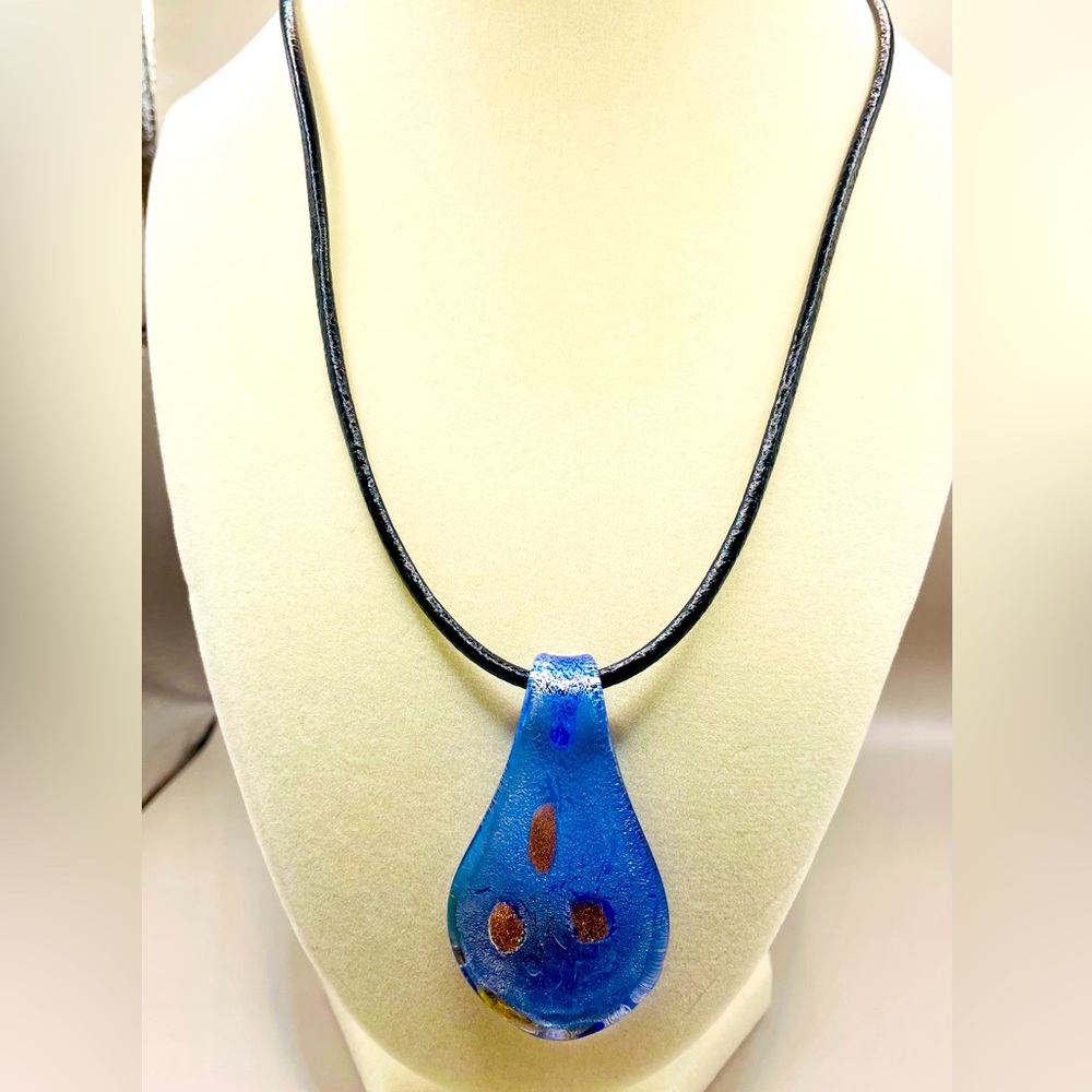Handmade blue glass rain drop pendant on a black cord necklace.